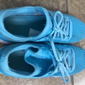 Aqua blue Nike shoes 
Light wear on bottom
